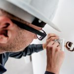 electrician working on electrical outlet
