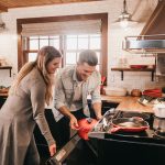 man and woman cooking with residential oven