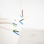 electrical cables sticking out of white wall