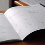 image of a large daily planner on a brown desk